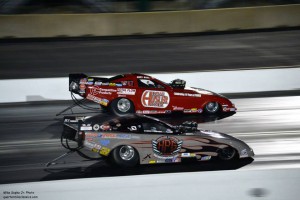 U-Haul Dealer Andy Bohl's red Top Alcohol Funny Car takes the lead on the track.
