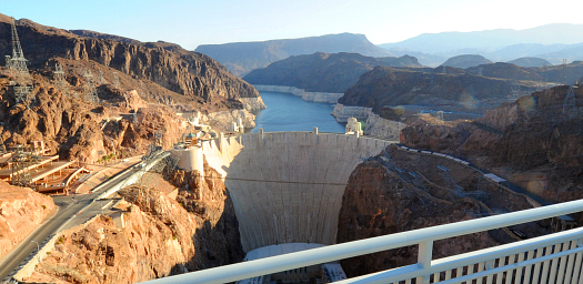 In this photo provided by the Las Vegas News Bureau, the first rays of sun start to illuminate the breath-taking view of Hoover Dam before crowds begin their journey from Arizona to Nevada during the public event to celebrate the completion of the Mike O'Callaghan-Pat Tillman Memorial Bridge over-looking Hoover Dam, called "Bridging America". Saturday, October 16, 2010. (Photo/Las Vegas News Bureau, Glenn Pinkerton)