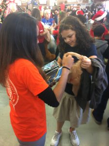 Armelyn Louis, a U-Haul Team Member, helps student bag Christmas gifts