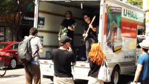 Slim Wray makes its music video Take It or Leave It from the back of a U-Haul truck in New York City.