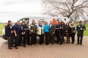 Roseville leaders and U-Haul Team Members pose in front of a U-Haul moving van to become #uhaulfamous.