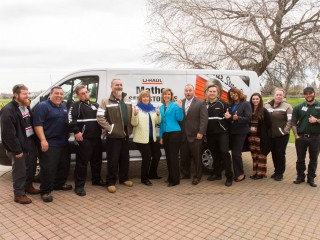 Roseville leaders and U-Haul Team Members pose in front of a U-Haul moving van to become #uhaulfamous.