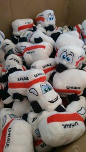 A box of Lil Sammy Mover Plush Toys and U-Haul Plush Toy Trailers