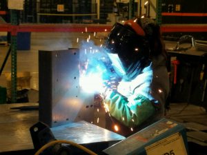 Richelle Begay spends her days brazing and soldering metals to precise specs from behind a welding helmet.