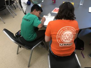 U-Haul Team Member Helping Student with Homework