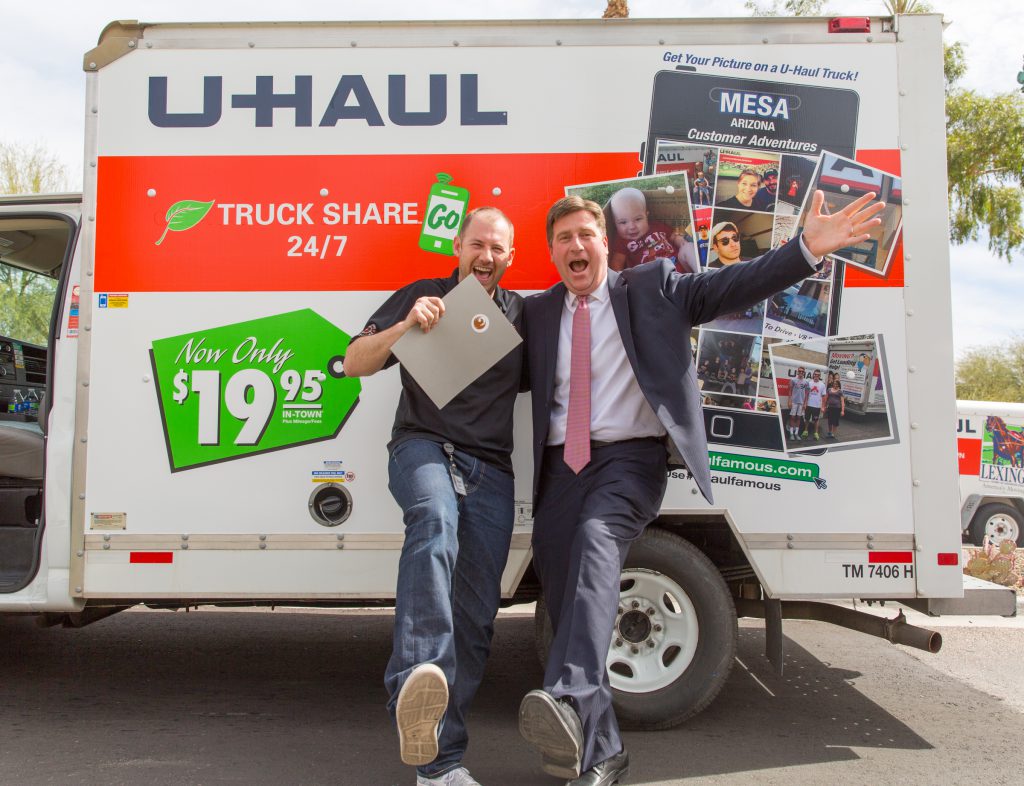 Stuart Shoen and Phoenix Mayor Greg Stanton pose for a U-Haul Famous photo during U-Haul Day festivities at the state capitol