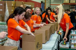 U-Haul volunteers pack emergency food boxes at St. Mary's Food Bank as part of Hunger Action Month.
