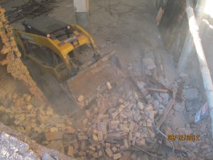 Bobcat clearing pavers and debris from U-Haul NBC-Nabisco Detroit building showroom