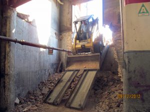 Lowering bobcat into U-Haul NBC-Nabisco building showroom